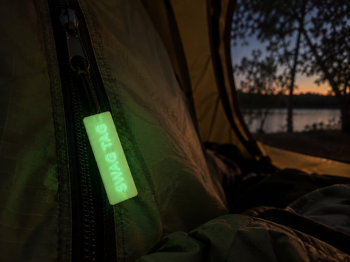 SwagTag glowing on camping tent at dusk